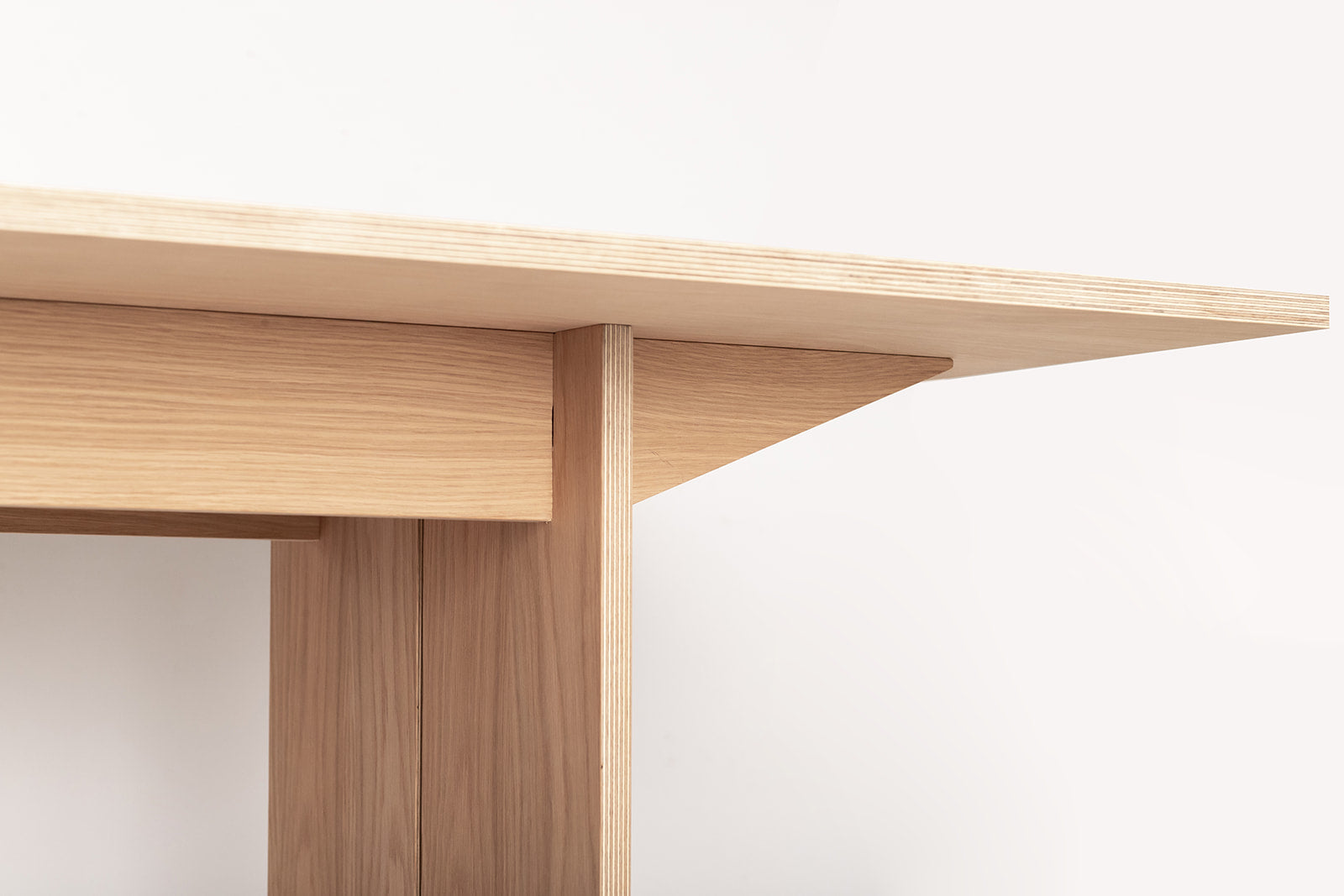 Side view of the dining table showing clean edges and sustainable canadian ply